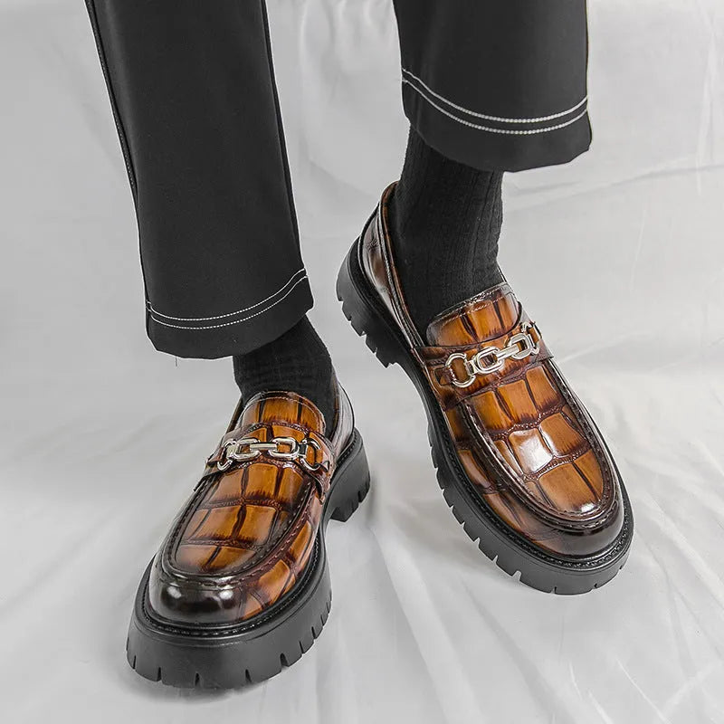 Men's black crocodile pattern leather loafers with a platform sole and flat heel.