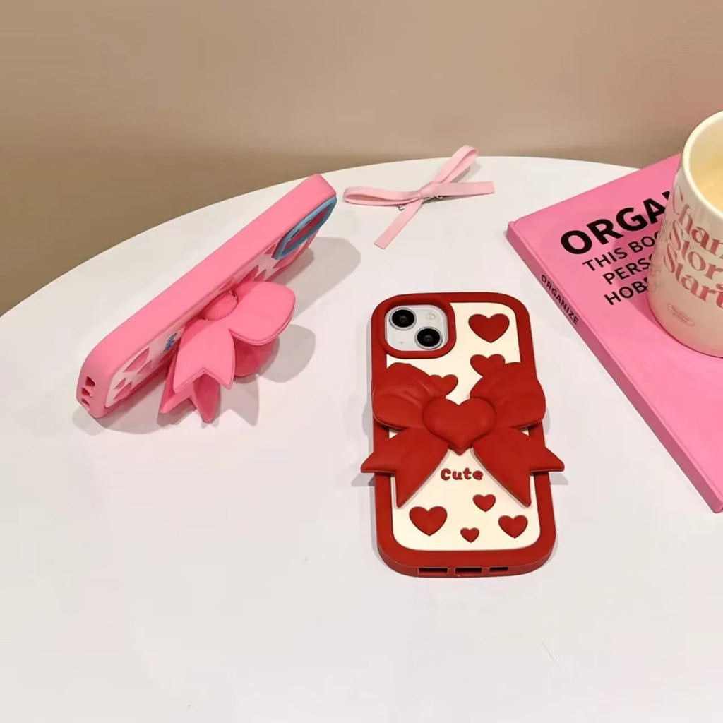 Pink 3D bow heart silicone phone case with hidden holder on iPhone, matte finish, Japanese Korean style design