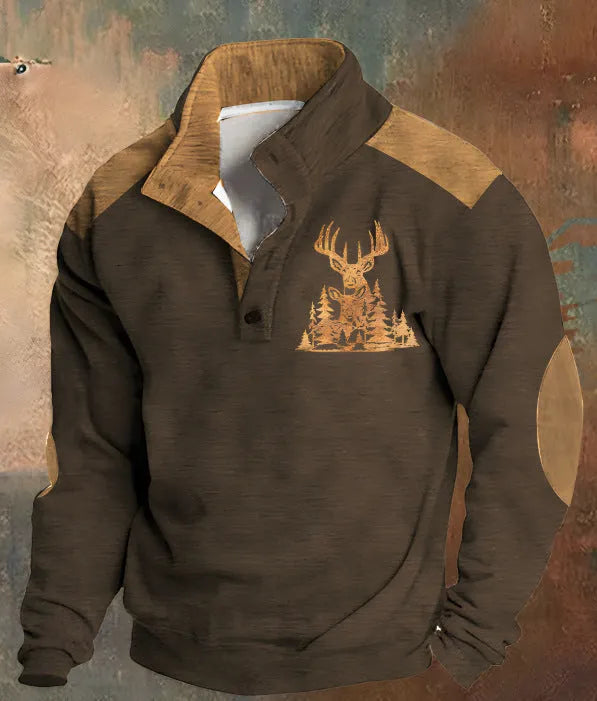Man wearing a loose fit grey sweater with a blue 3D digital print pattern and four buttons down the front.