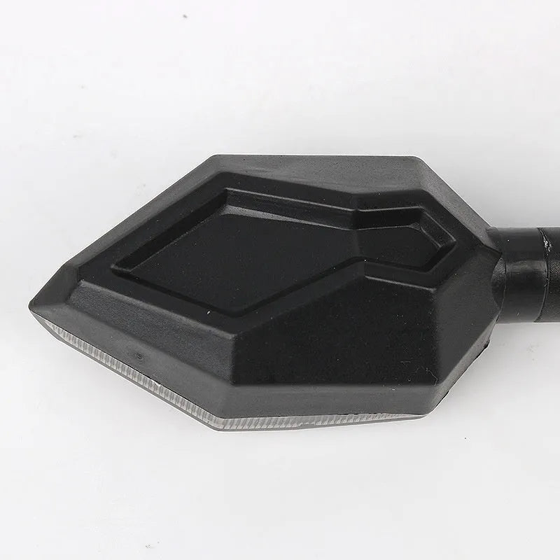 Arrow-shaped LED motorcycle turn signal lamp in ABS plastic housing for 12v universal vehicle fit.