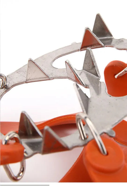 Reinforced non-slip crampons for shoes in black colour with large teeth, shown on a snowy surface