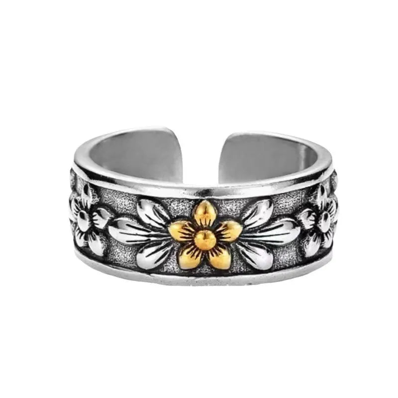 Vintage antique silver gold flower open ring with camellia design on a plain background