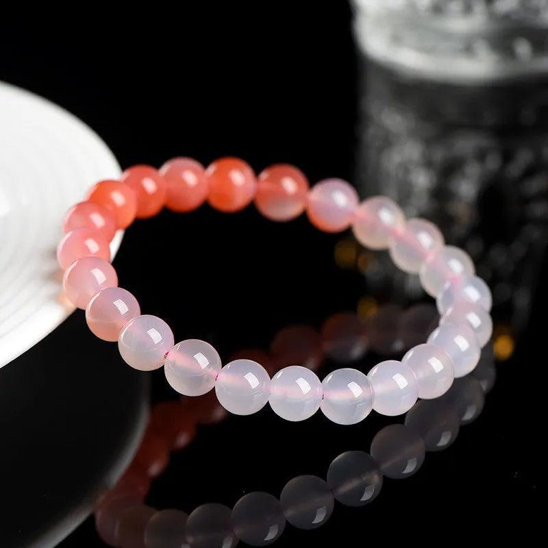 Yanyuan agate bracelet with gradient salt source coloured beads in a geometric shape on a wrist.