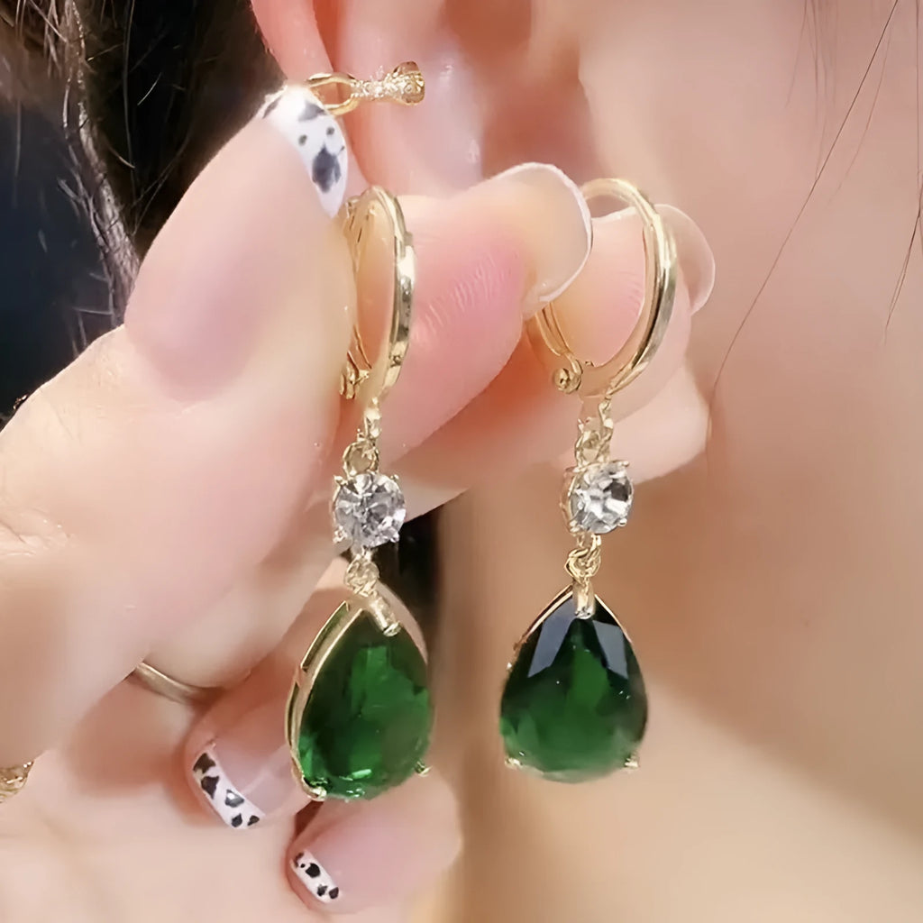A pair of geometric teardrop-shaped earrings in emerald green colour.