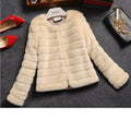 Women's short artificial fur top in beige colour with regular sleeves on a model.