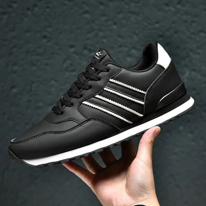Men's black leather casual sports shoes with carved wing pattern detail and a high heel.