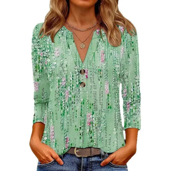 Women's loose-fit grey V-neck top with a white 3D geometric pattern print on the front.
