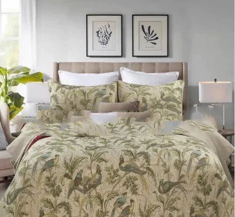 Blue American floral and bird pattern quilted cotton bedspread draped on a double bed
