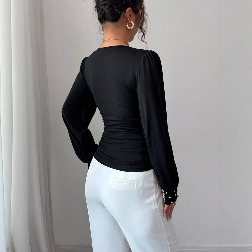 Women's V-neck solid colour fitted t-shirt with long bell sleeves in black, wine red, or apricot.