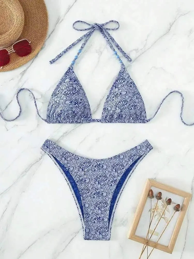 Women's floral bikini halter set with sleeveless top and shorts in polyester fabric.