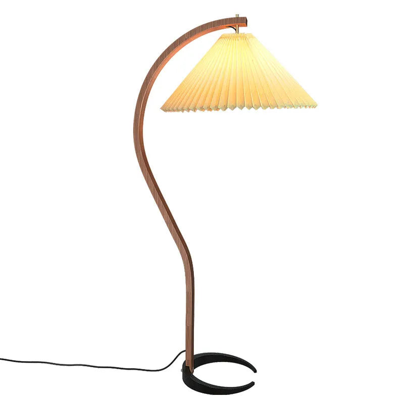 Retro vertical table lamp with a fabric shade in log white, placed on a bedside table.