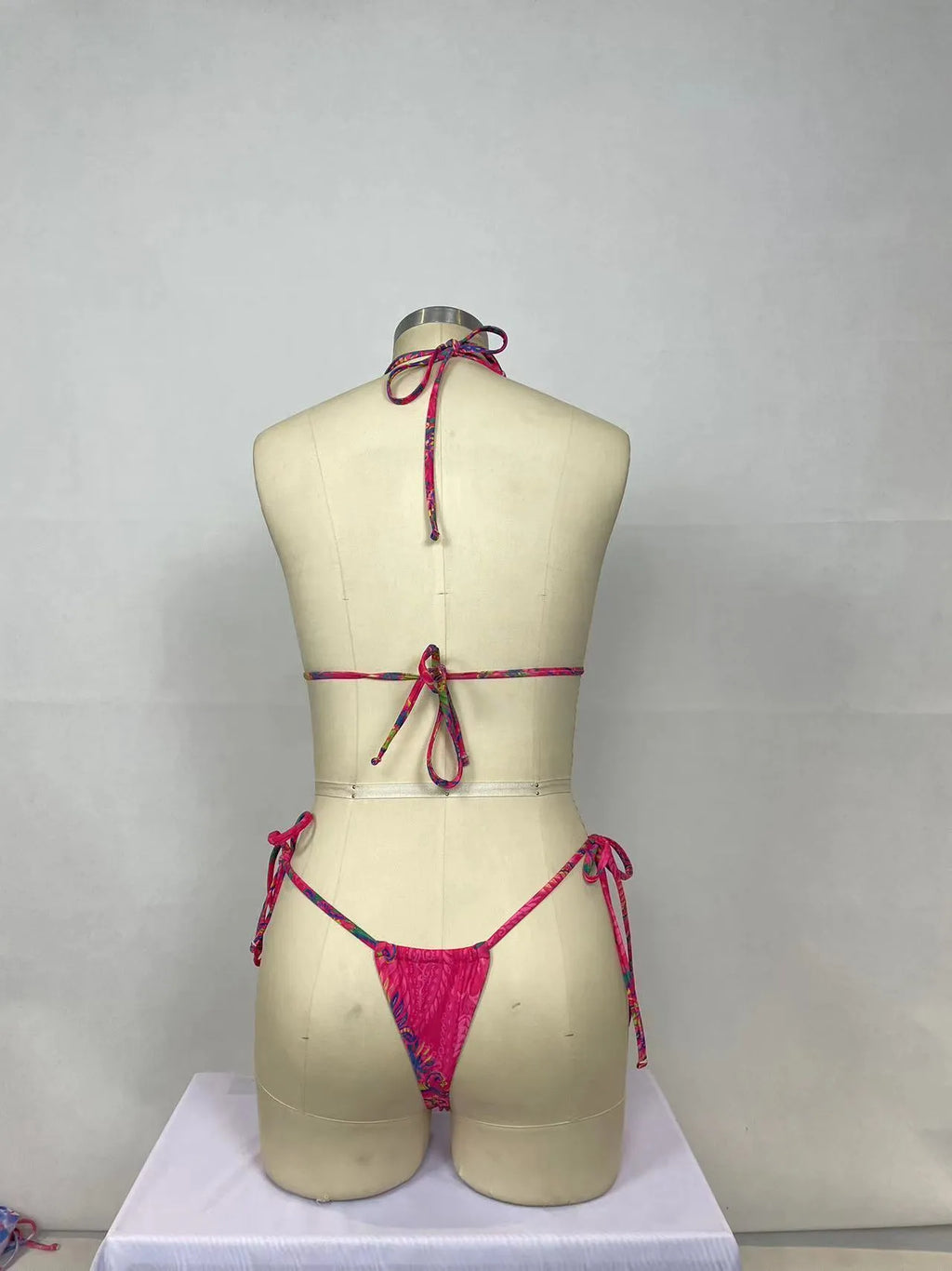 Pink women's two-piece bikini swimsuit set with briefs styling