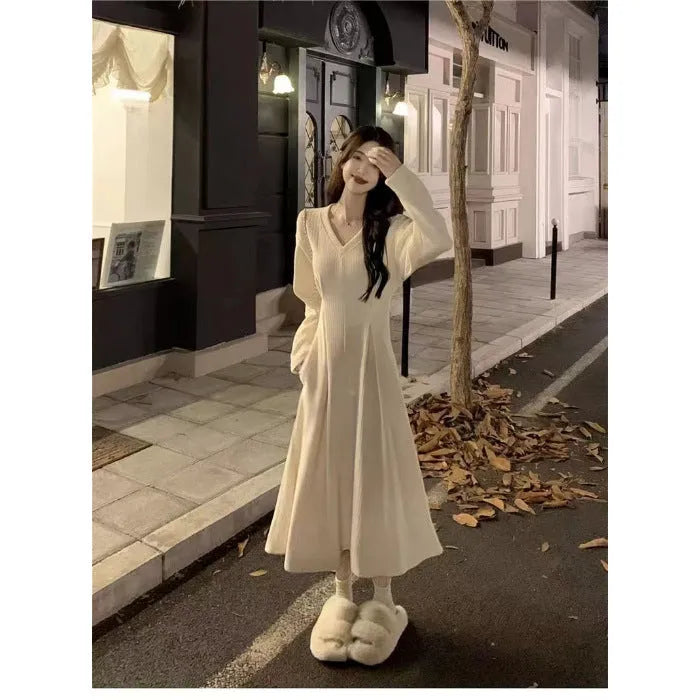 Women's V-neck knitted dress with princess sleeves in milky white colour showing long skirt length