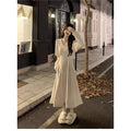 Women's V-neck knitted dress with princess sleeves in milky white colour showing long skirt length