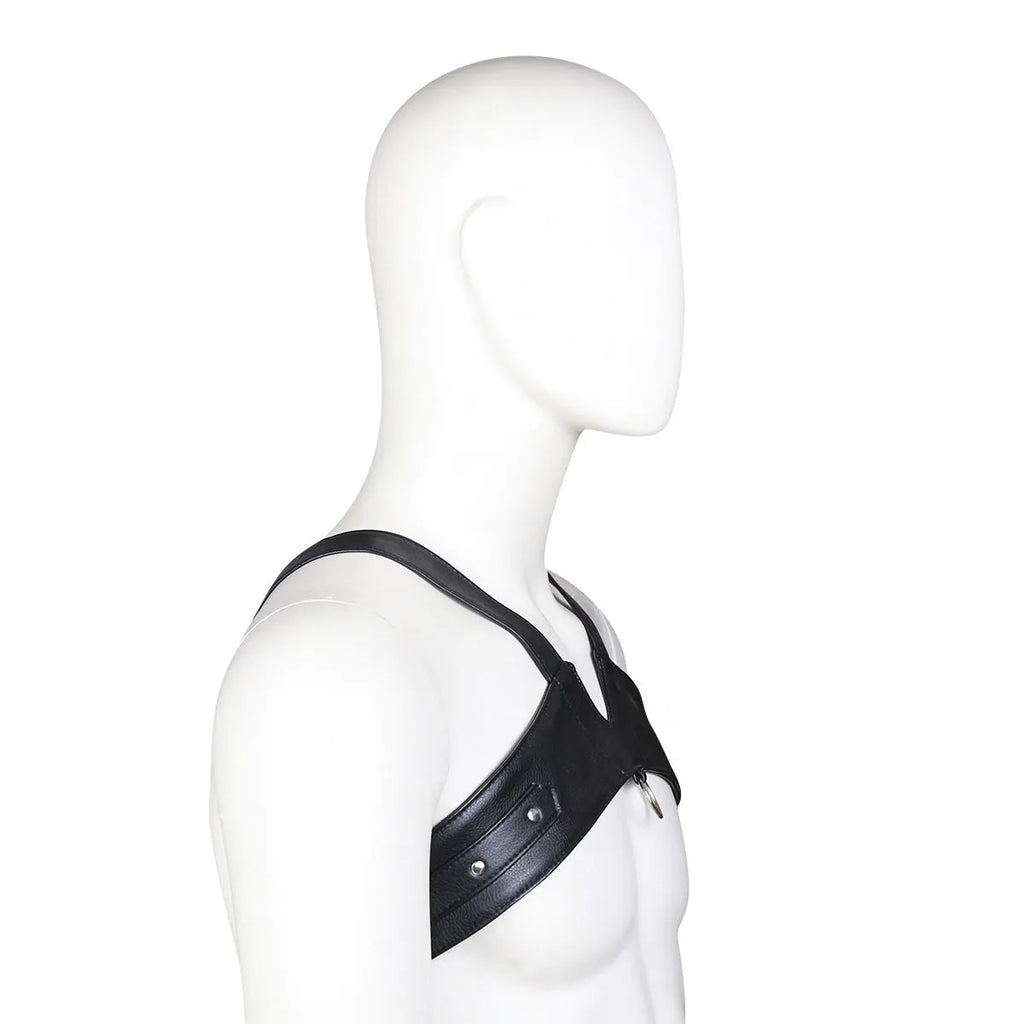 Black leather adjustable men's chest strap harness laid flat on a neutral background with adjustable fastener visible