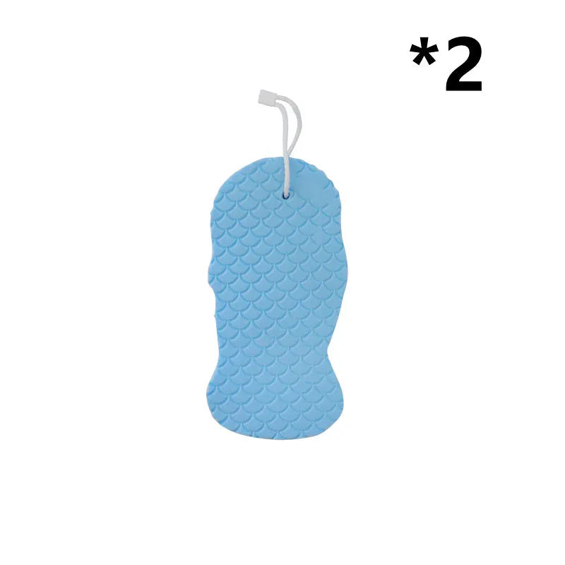 White 3D fish scale pattern bath sponge with hang loop on a bathroom background.