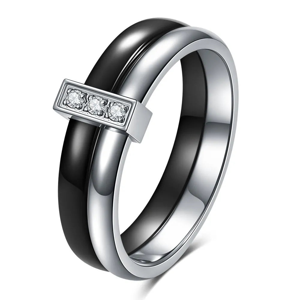 Geometric glossy ceramic women's ring with zirconium inlay, shown in steel black and gold white.