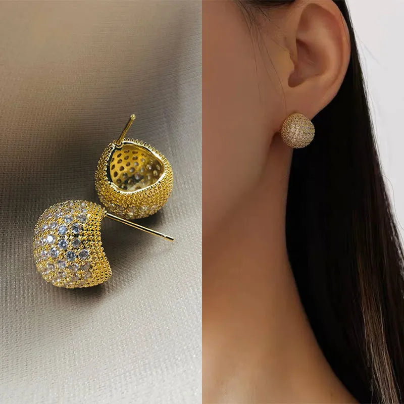 Women's drop-shaped clip earrings with full diamond elements and golden beans detailing