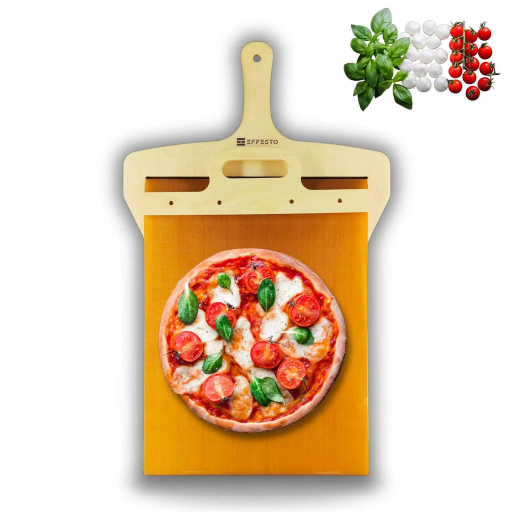 White plastic pizza transfer shovel on a kitchen counter, showing its flat board surface and handle with hanging hole.