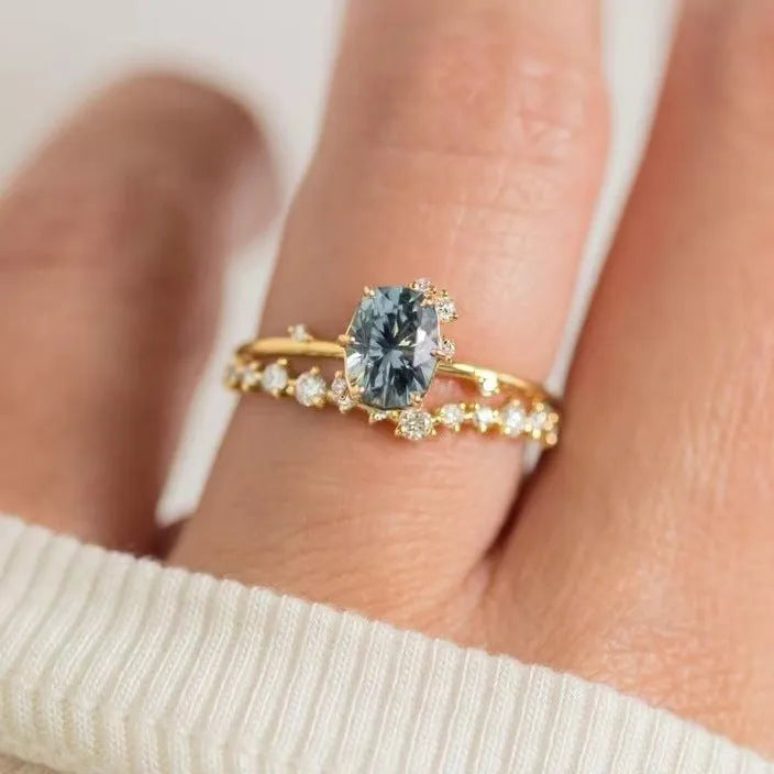 Women's gold floral ring with a green zircon stone, shown as a pair.