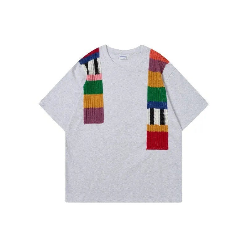 Men's loose grey cotton T-shirt with black and white patchwork letter design on chest.