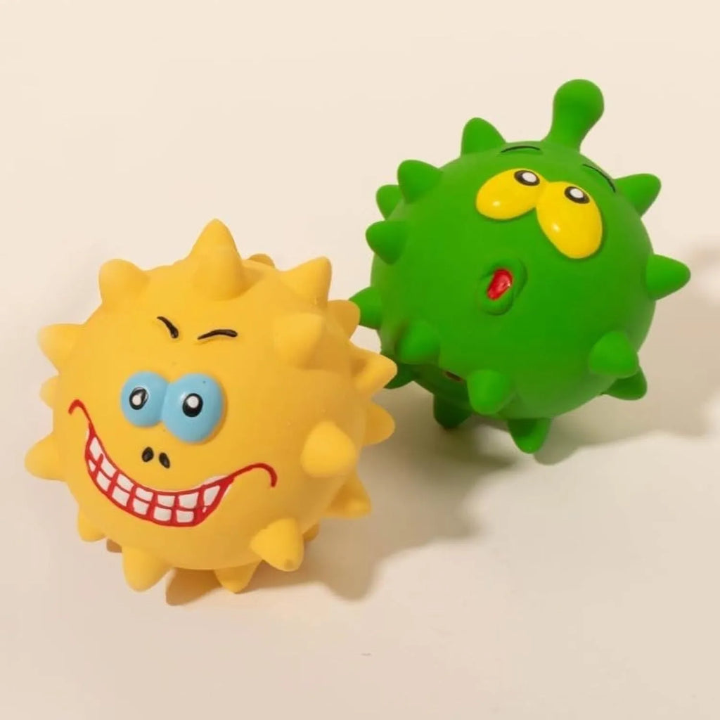 Set of four colourful latex squeaky dog balls with cute faces, shown next to a dog.