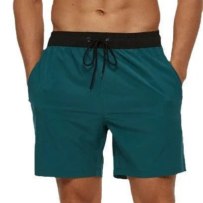Men's blue drawstring athletic shorts with a zip pocket and stitching detail on the waistband.