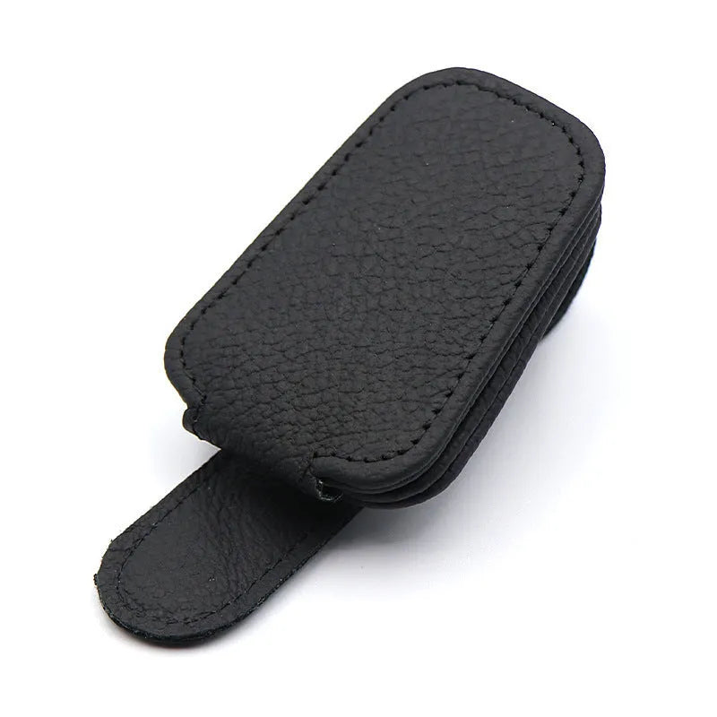 PU leather car sunglasses clip holder mounted on a grey sun visor.