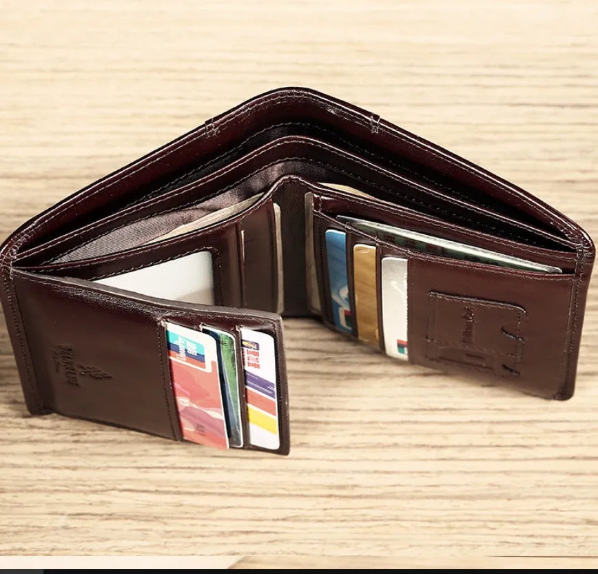 Men's black genuine leather bifold wallet open, showing eight card slots and a zipped coin compartment.