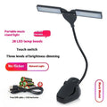 Black rechargeable music stand lamp with 28 soft white LEDs clipped to a metal music stand.