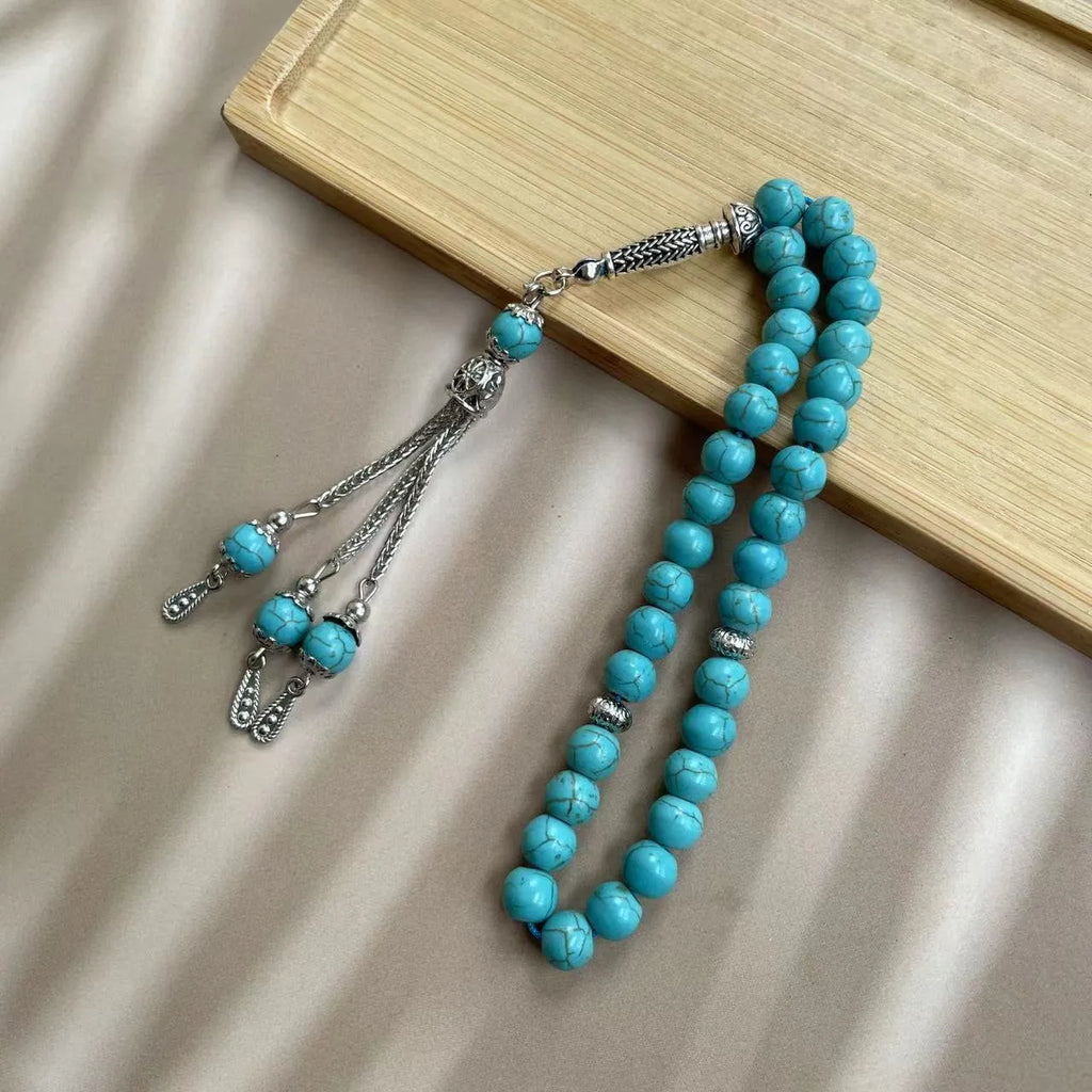 Handmade Muslim prayer bracelet made of sky blue 8mm stone beads on a wrist.