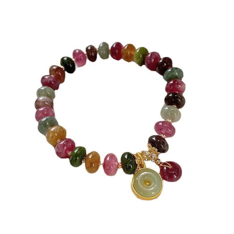 Close-up of a colourful tourmaline rabbit pendant bracelet with natural stone round beads.