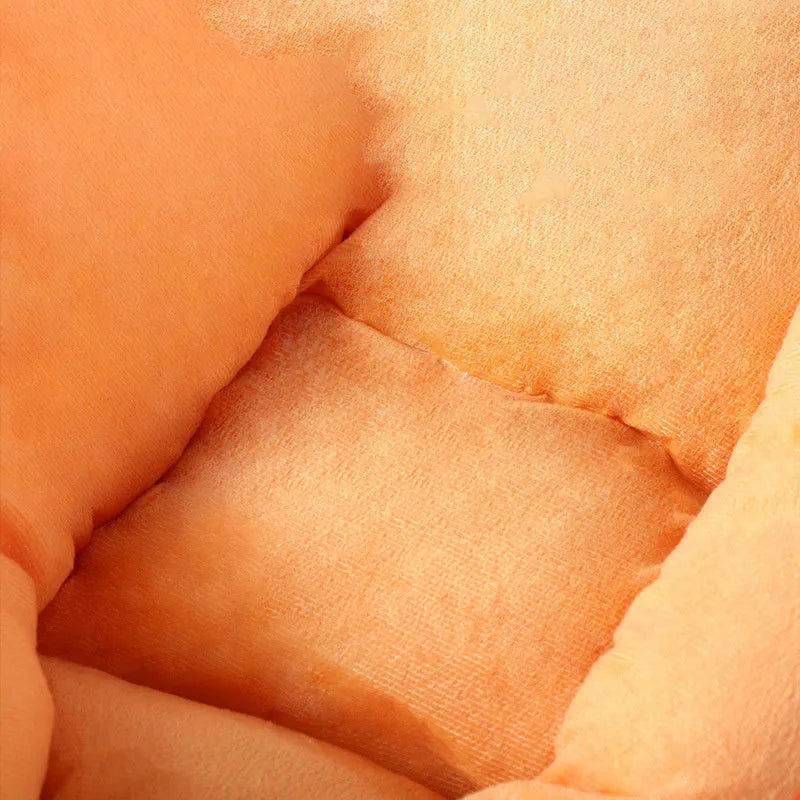 Orange carrot-shaped dog nesting bed with a raised bolster edge and a separate soft blanket, shown in two sizes.