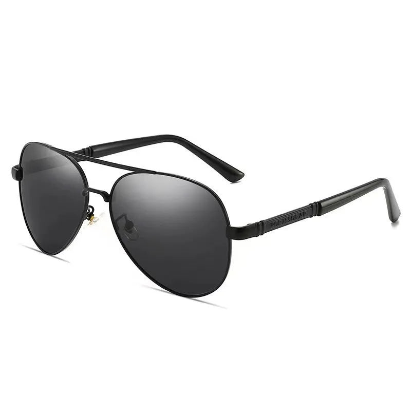 Men's gold metal frame polarised sunglasses with dragon and phoenix decoration and grey lenses on a table.