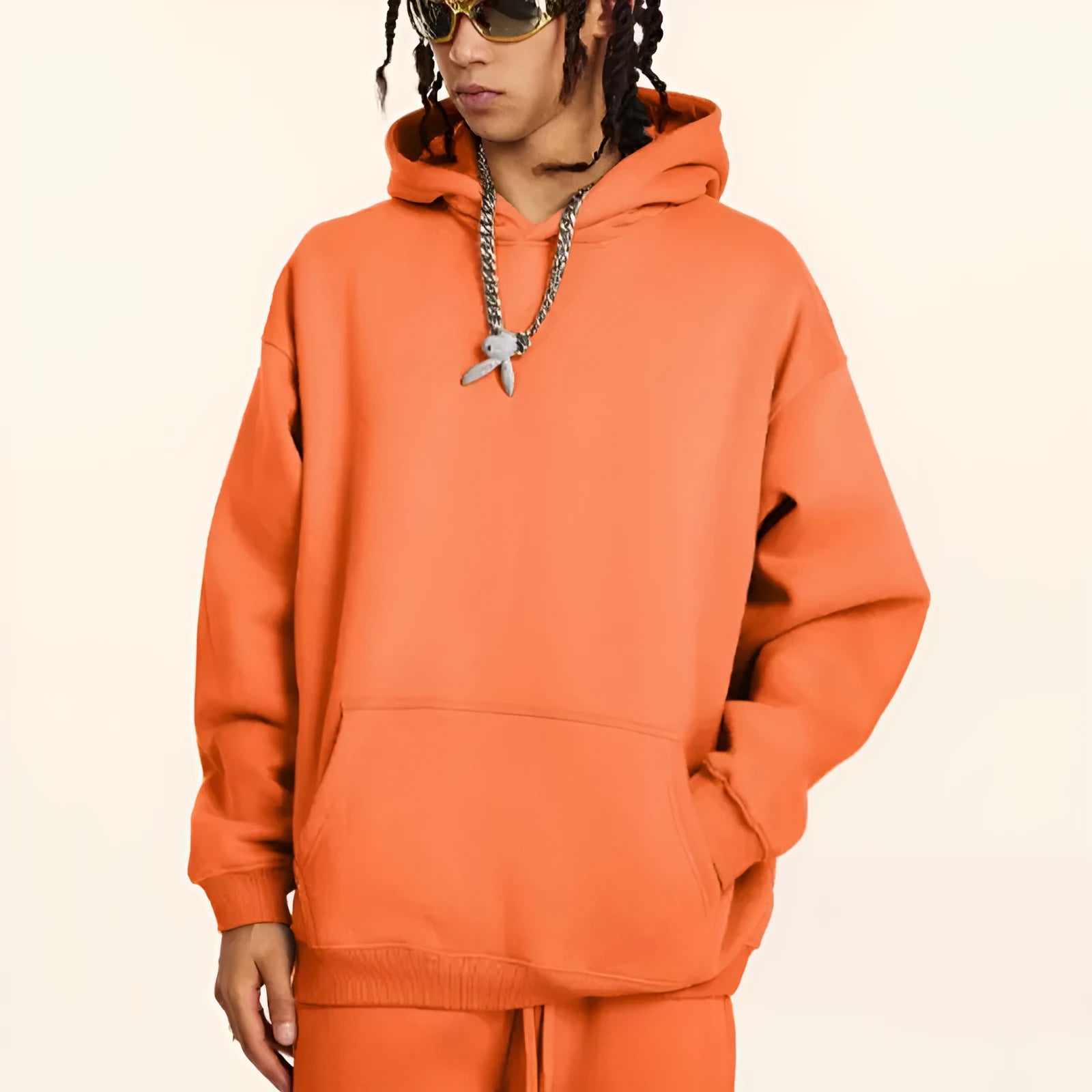 A man wearing a loose-fit, hooded terry cotton sweatshirt in a caramel colour.
