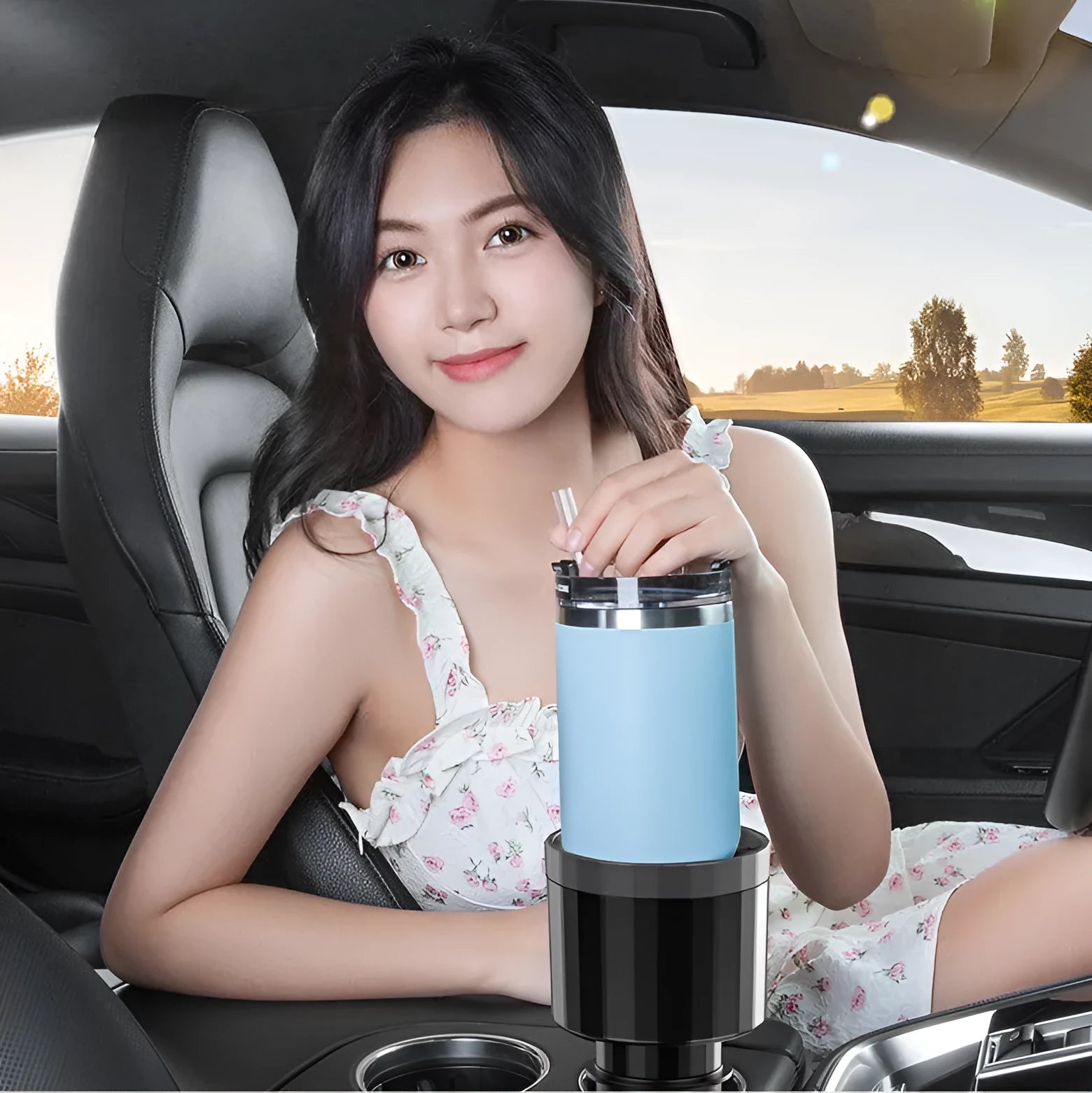 Matte black adjustable car cup holder expander for large bottles and cups on a car console.