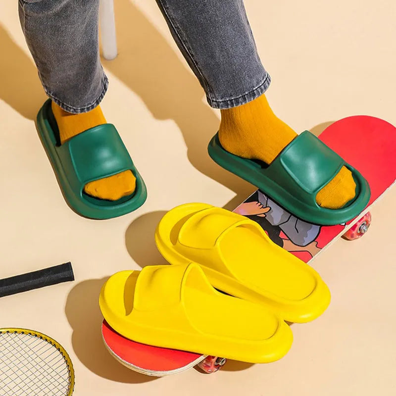 Soft EVA slippers with thick non-slip sole in various colours on a bathroom floor.