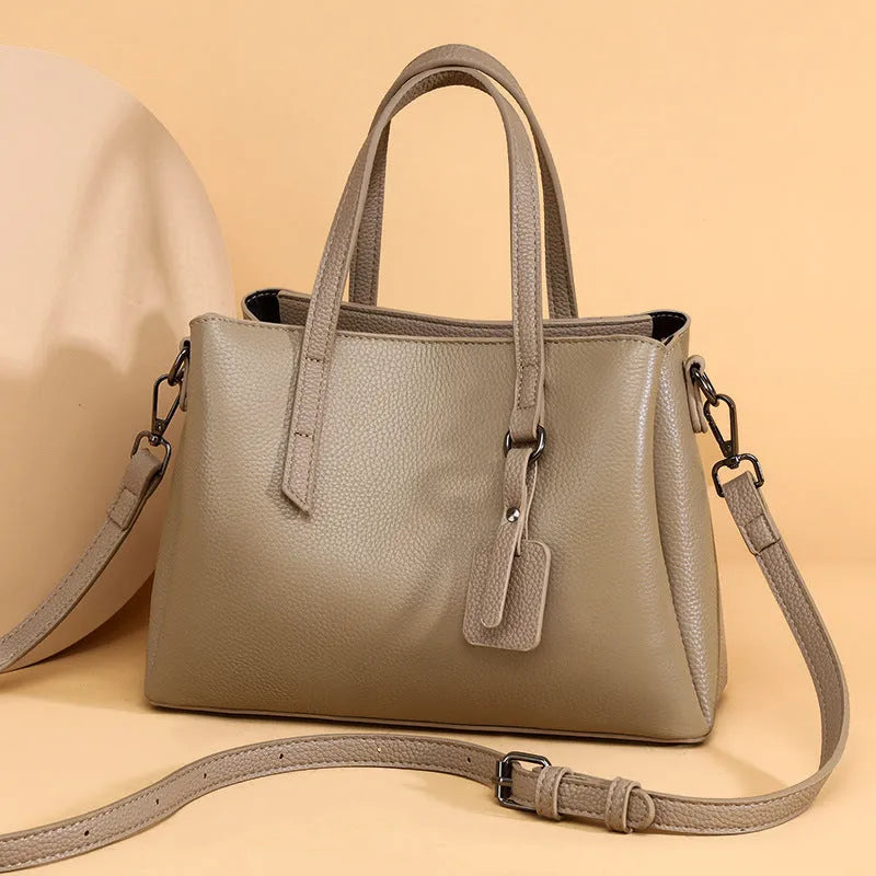 Genuine cowhide leather women's large capacity shoulder handbag in horizontal square shape with organiser pockets.
