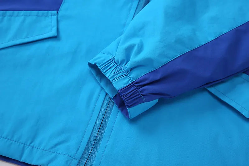 Blue thin children's autumn jacket with long sleeves and a front zip, laid flat showing size label.