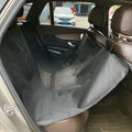 Grey car pet mat with dog bone print covering a vehicle's rear seat.