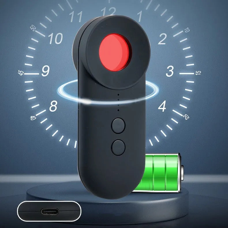 Black portable anti-car GPS and wifi signal detector with a USB cable on a table.