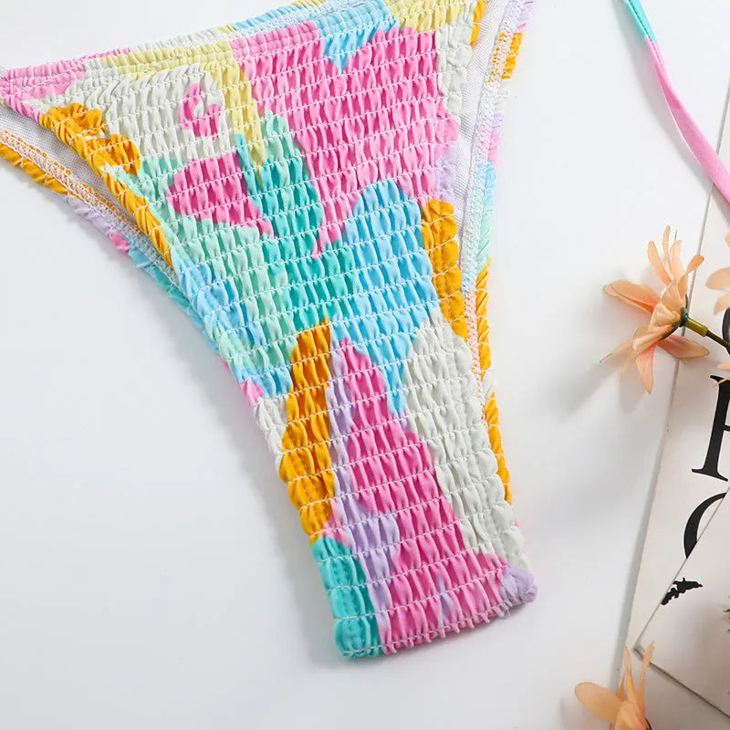 Women's triangle bag bikini swimsuit with printed floral gradient pattern and smocking detail