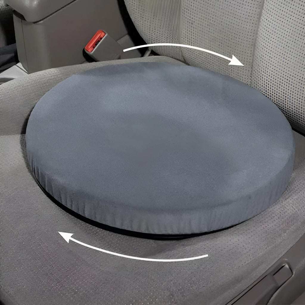 A grey rotating car seat cushion on a car seat, showing its non-slip base and plush fabric texture.