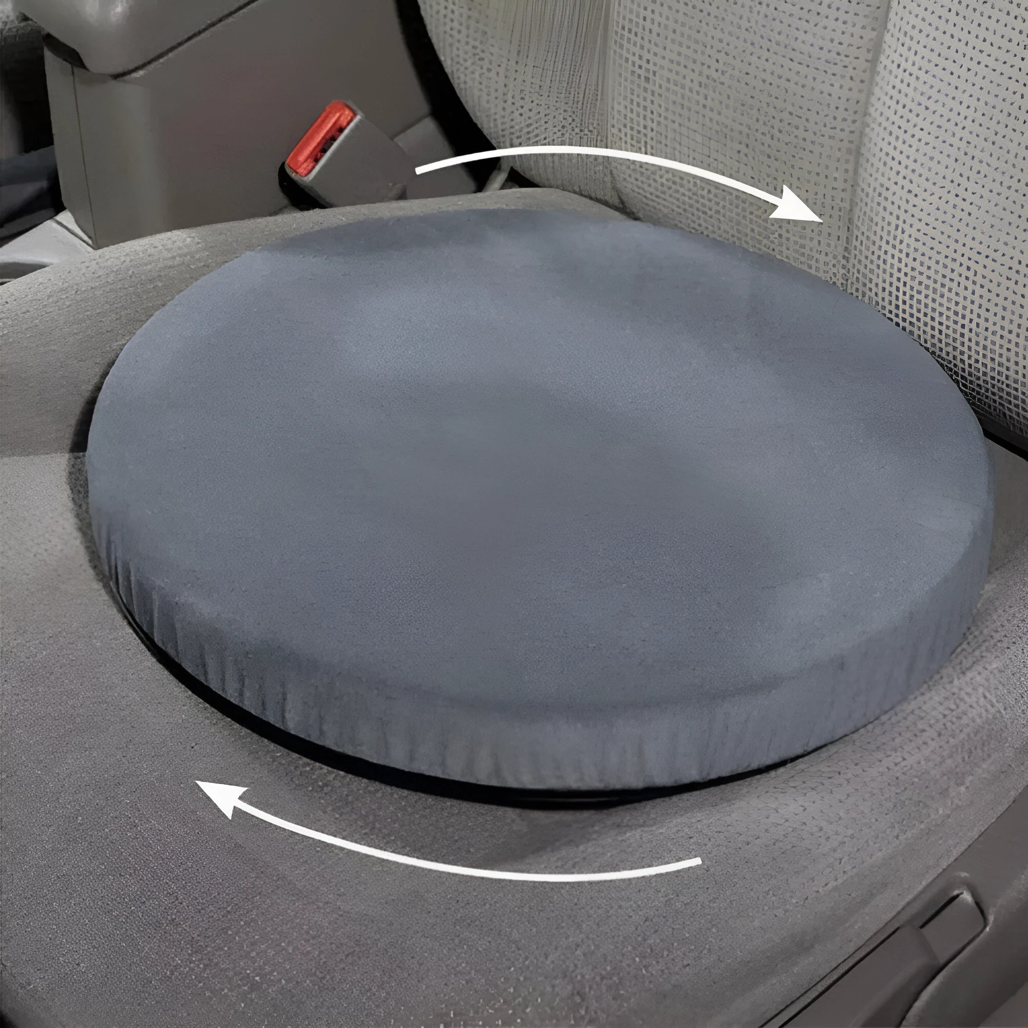 A grey rotating car seat cushion on a car seat, showing its non-slip base and plush fabric texture.