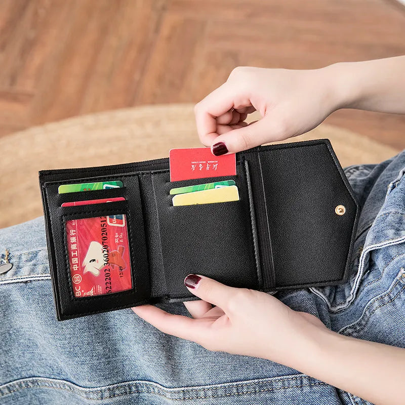Women's PU leather tri-fold wallet with magnetic buckle, card slots, and coin pocket in black