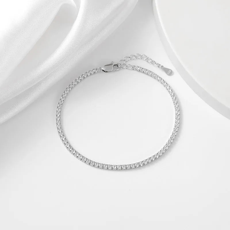 Geometric silver bracelet with zircon inlay, white gold finish, 3mm stone on a flat surface