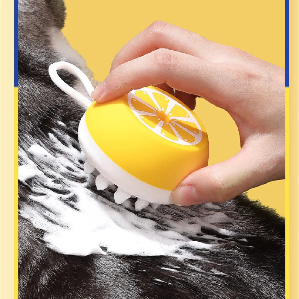 Yellow silicone pet bath brush with massage bristles and comb teeth on a blue background.