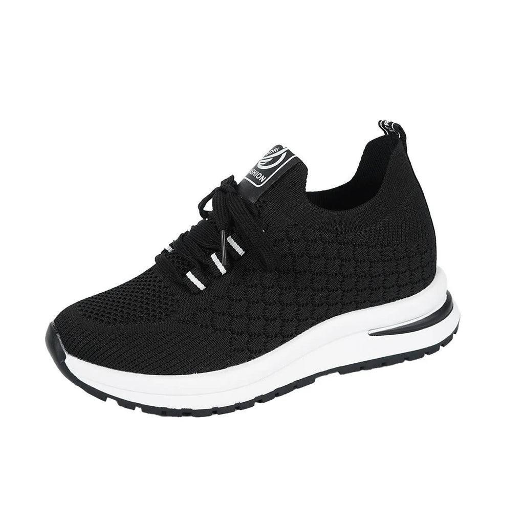 Women's black and white lace-up mesh platform sneakers with a flat rubber sole on a neutral background.