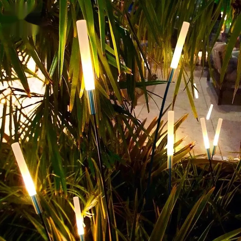 Solar outdoor LED lawn lamp with acrylic shade, available in multiple heights, installed in a garden.