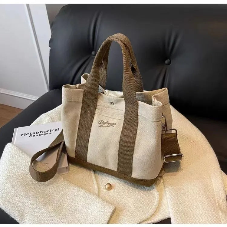 Beige canvas messenger bag with three shoulder straps and sandwich pocket for outdoor and everyday use